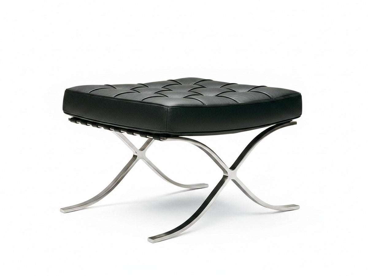 Repose-pieds du Fauteuil Capiton sur fond blanc : cuir capitonné et châssis d'acier croisé